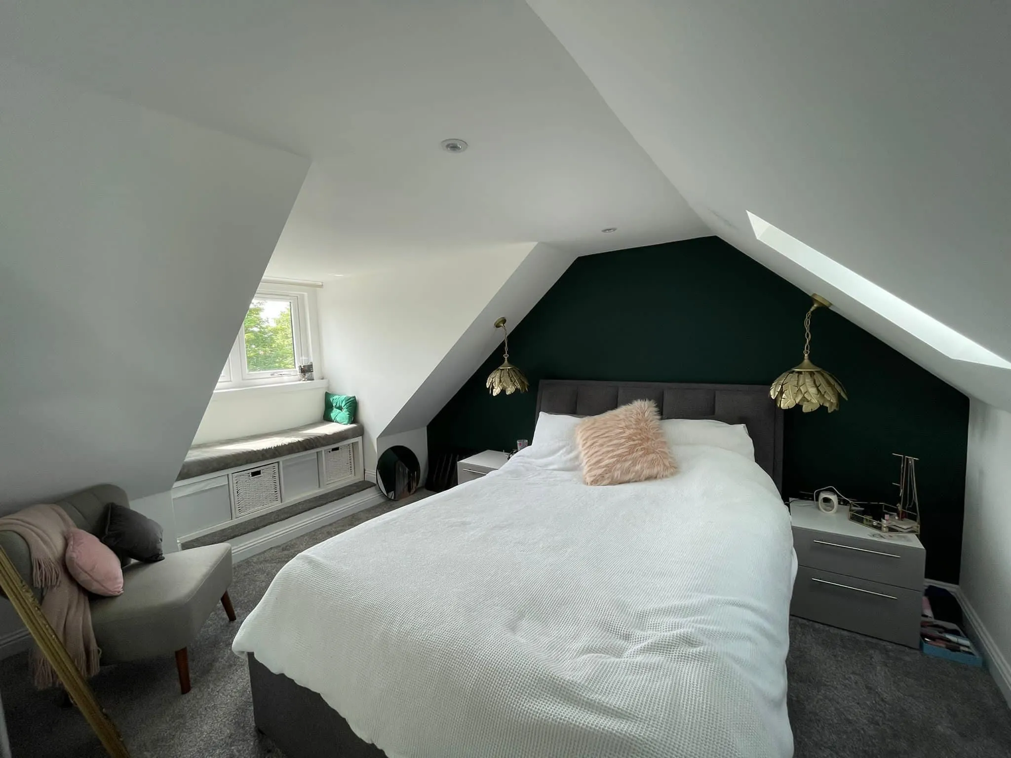 A bedroom with a bed and a chair in it.
